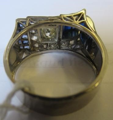 AN ART DECO STYLE SAPPHIRE AND DIAMOND "BUCKLE" COCKTAIL RING Image
