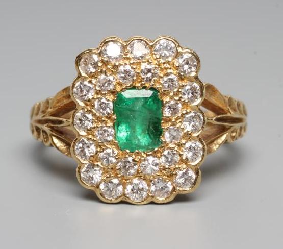 AN EMERALD AND DIAMOND CLUSTER DRESS RING Image