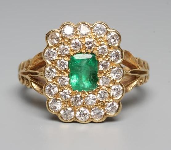AN EMERALD AND DIAMOND CLUSTER DRESS RING Image