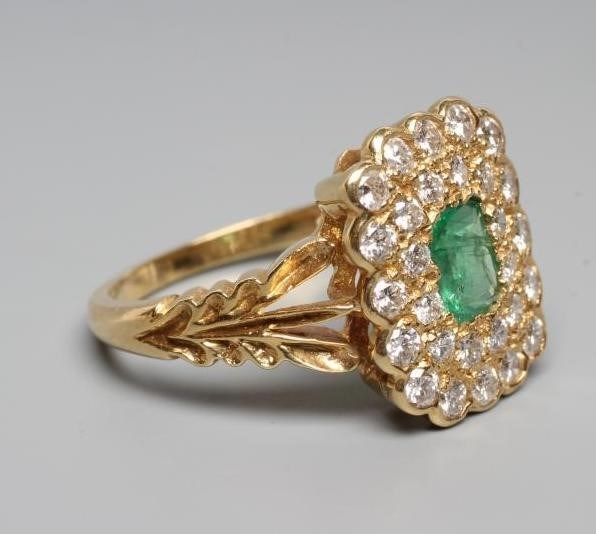 AN EMERALD AND DIAMOND CLUSTER DRESS RING Image