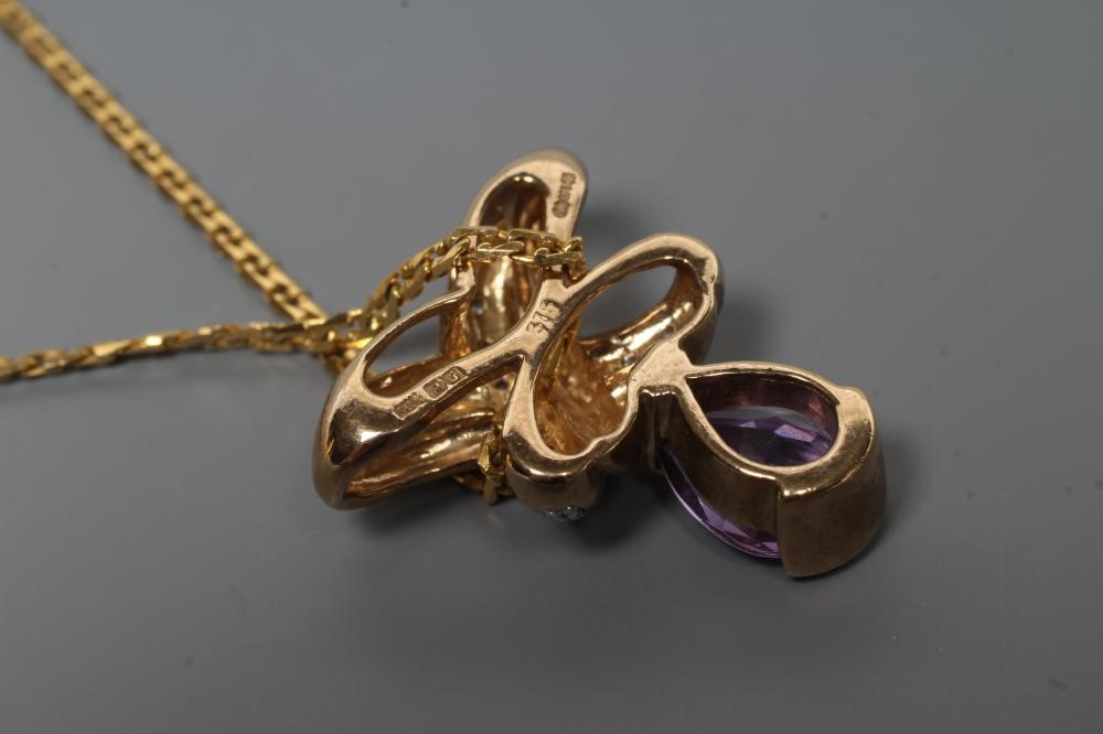 AN AMETHYST AND DIAMOND PENDANT Image