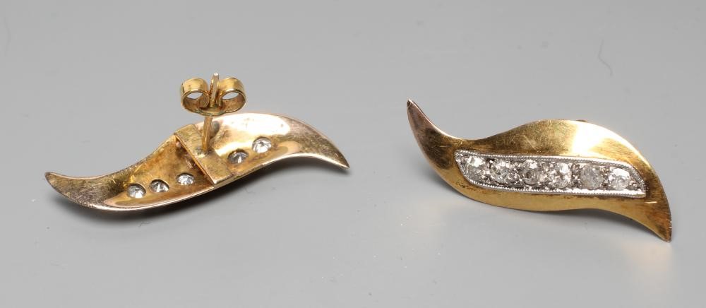 A PAIR OF DIAMOND STUD EARRINGS, the stylised "S" panels pave set with a line of six mixed cut Image