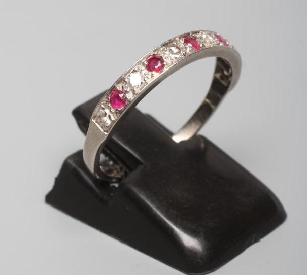 A RUBY AND DIAMOND HALF HOOP RING, the five rubies and six diamonds point set to a plain white shank Image