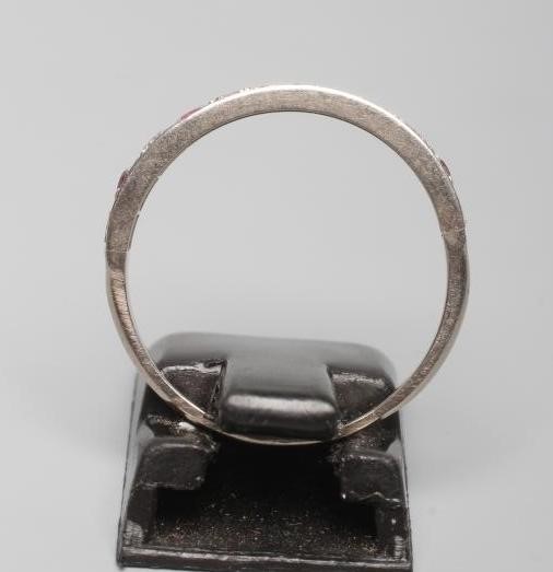 A RUBY AND DIAMOND HALF HOOP RING, the five rubies and six diamonds point set to a plain white shank Image