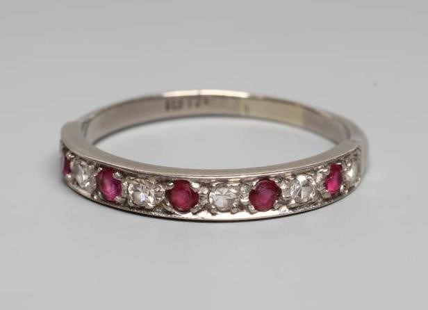 A RUBY AND DIAMOND HALF HOOP RING, the five rubies and six diamonds point set to a plain white shank Image