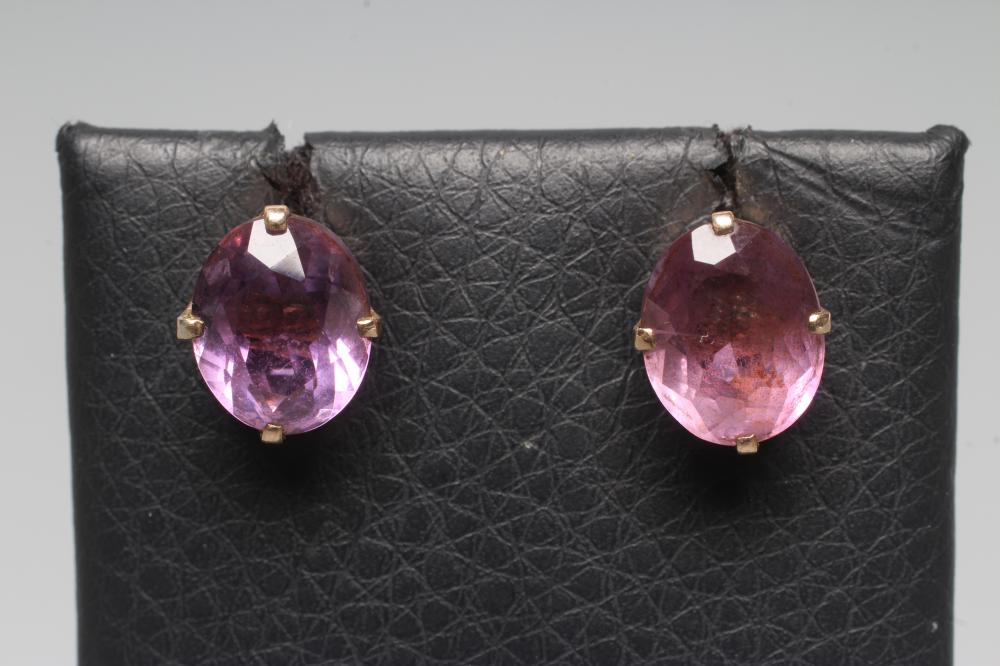 A PAIR OF AMETHYST EAR STUDS, the oval facet cut stones claw set to a plain unmarked frame (Est. Image