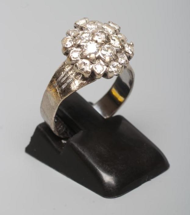 A DIAMOND CLUSTER RING, the mix cut stones claw set to a later white unmarked shank, size L (Est. Image
