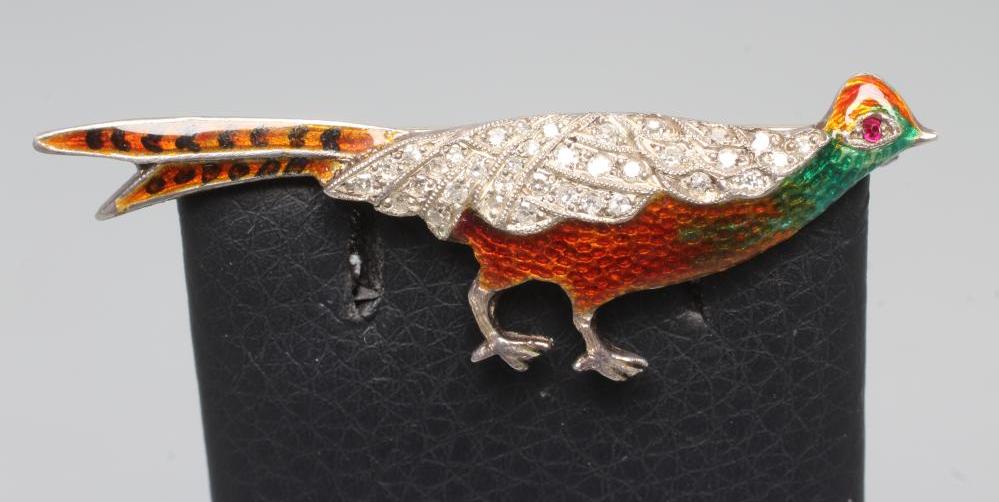 AN EDWARDIAN DIAMOND AND ENAMEL NOVELTY BROOCH modelled as a cock pheasant with pave set diamond Image