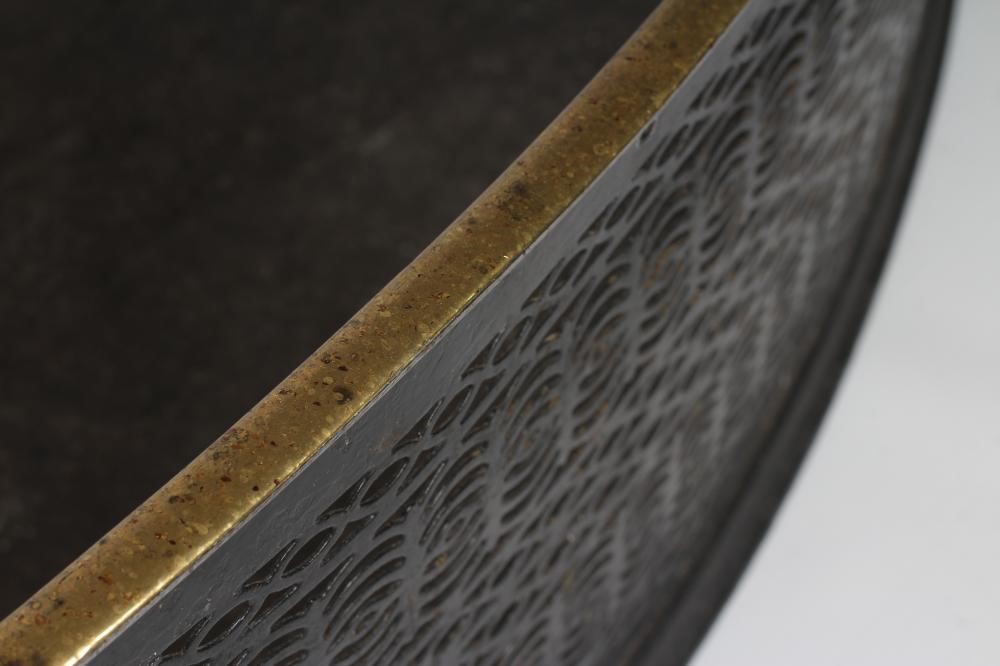 A GEORGIAN CUT STEEL FENDER, late 18th century, of curved outline with brass trim, pierced with Image