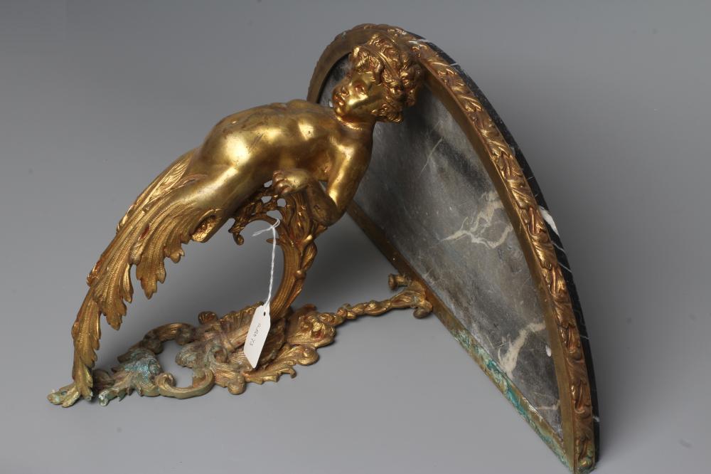 A GILT METAL FIGURAL WALL BRACKET, late 19th century, modelled as a putto supporting a demi-lune Image