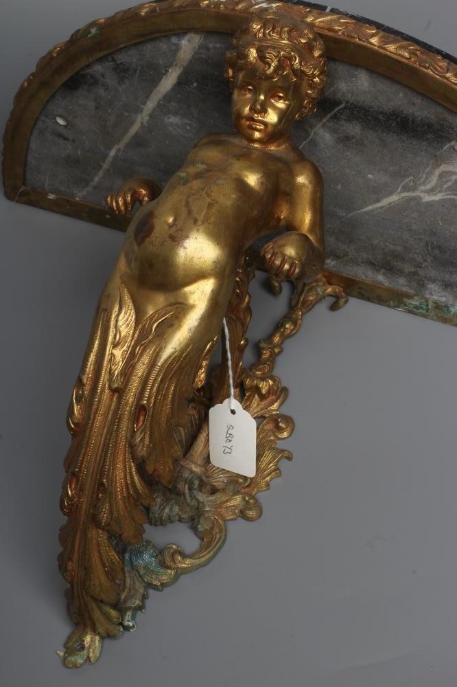 A GILT METAL FIGURAL WALL BRACKET, late 19th century, modelled as a putto supporting a demi-lune Image
