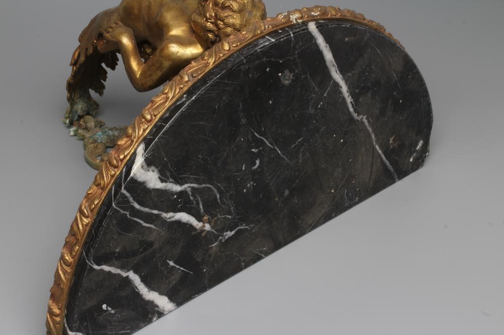 A GILT METAL FIGURAL WALL BRACKET, late 19th century, modelled as a putto supporting a demi-lune Image