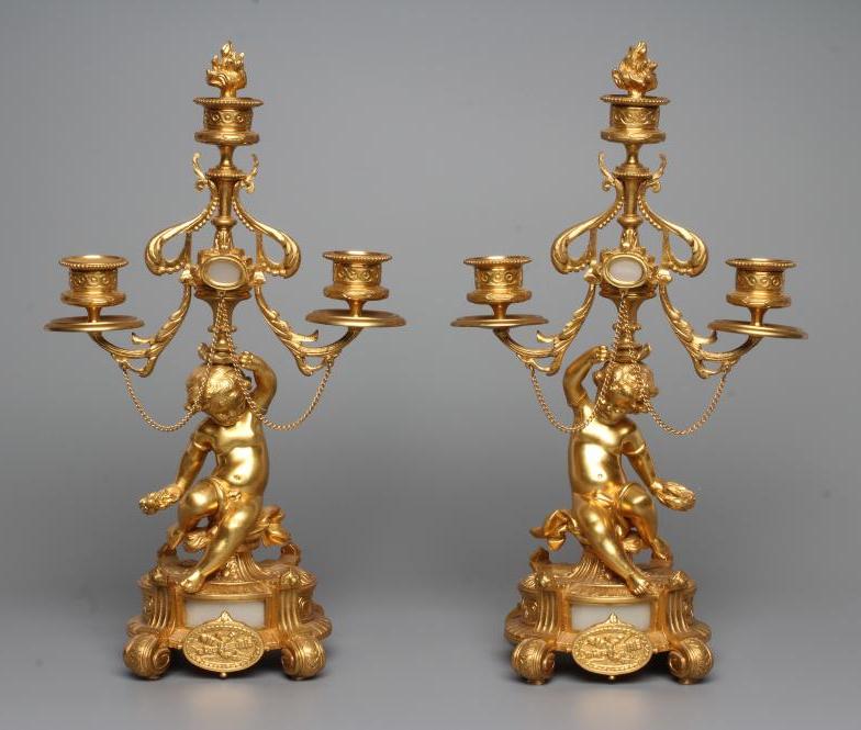 A PAIR OF FRENCH GILT METAL THREE LIGHT FIGURAL CANDELABRA inset with onyx panels Image