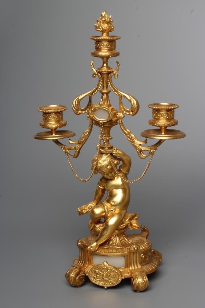 A PAIR OF FRENCH GILT METAL THREE LIGHT FIGURAL CANDELABRA inset with onyx panels Image