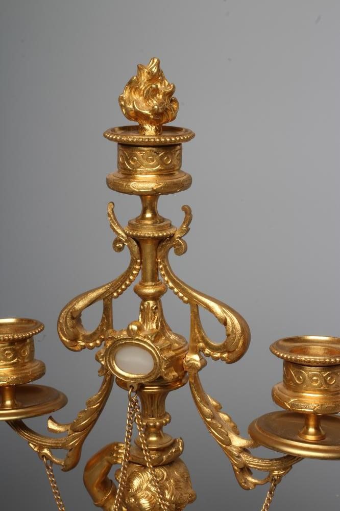 A PAIR OF FRENCH GILT METAL THREE LIGHT FIGURAL CANDELABRA inset with onyx panels Image