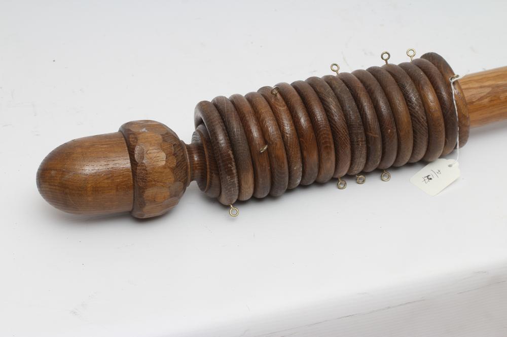 AN ADZED OAK CURTAIN POLE BY ALAN GRAINGER OF BRANDSBY, in two sections with wooden hanging rings Image