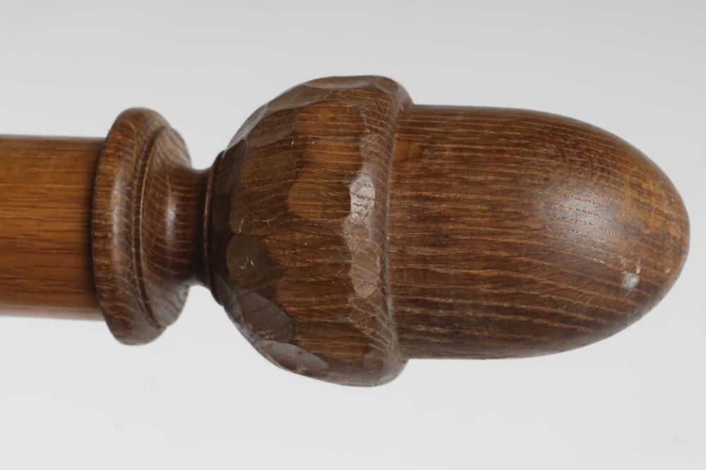 AN ADZED OAK CURTAIN POLE BY ALAN GRAINGER OF BRANDSBY, in two sections with wooden hanging rings Image