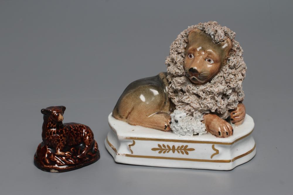 A STAFFORDSHIRE PORCELANEOUS LION Image