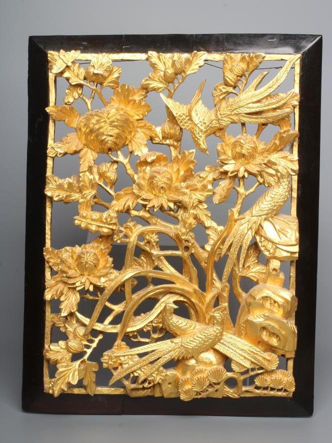 A CHINESE GILT WOOD AND BLACK LACQUERED PANEL, c.1900, the centre pierced and carved in high relief Image