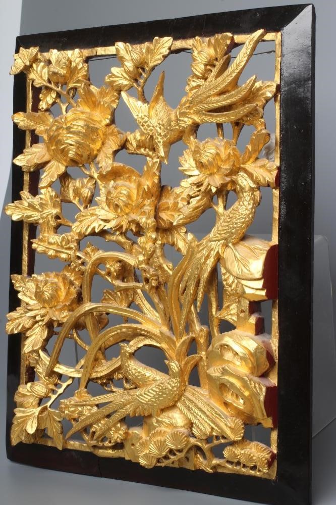 A CHINESE GILT WOOD AND BLACK LACQUERED PANEL, c.1900, the centre pierced and carved in high relief Image