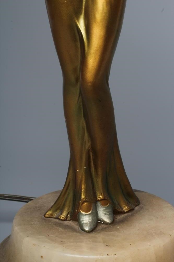 AN ART DECO BRONZED SPELTER FIGURAL ELECTRIC LAMP BASE modelled as a young lady with shingled hair Image