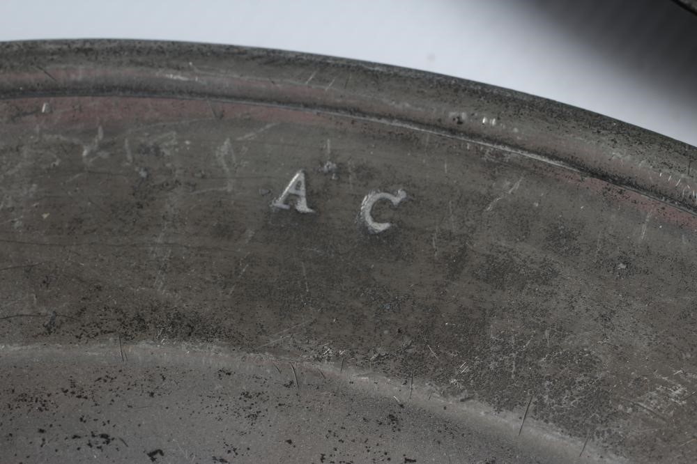 A GEORGIAN PEWTER DISH, 18th century, with single rim and ownership initials 13 1/2" wide, together Image