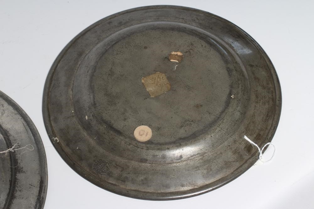 A GEORGIAN PEWTER DISH, 18th century, with single rim and ownership initials 13 1/2" wide, together Image