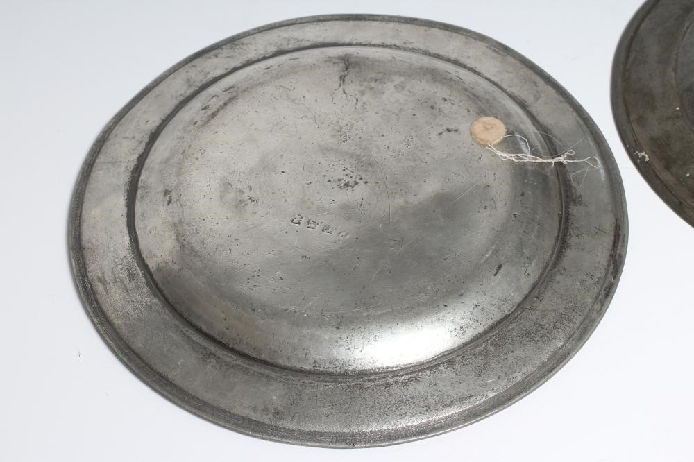 A GEORGIAN PEWTER DISH, 18th century, with single rim and ownership initials 13 1/2" wide, together Image