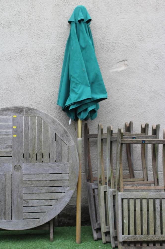 A TEAK TABLE AND CHAIRS, manufactured by Neptune, the folding circular slatted table 42 1/2" wide, Image