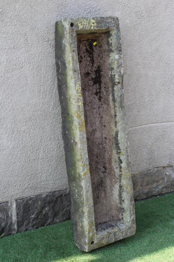 A SANDSTONE TROUGH of rough hewn narrow oblong form, 49 1/2" x 14"x 6 1/4" (Est. plus 24% premium Image