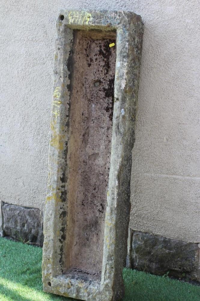 A SANDSTONE TROUGH of rough hewn narrow oblong form, 49 1/2" x 14"x 6 1/4" (Est. plus 24% premium Image
