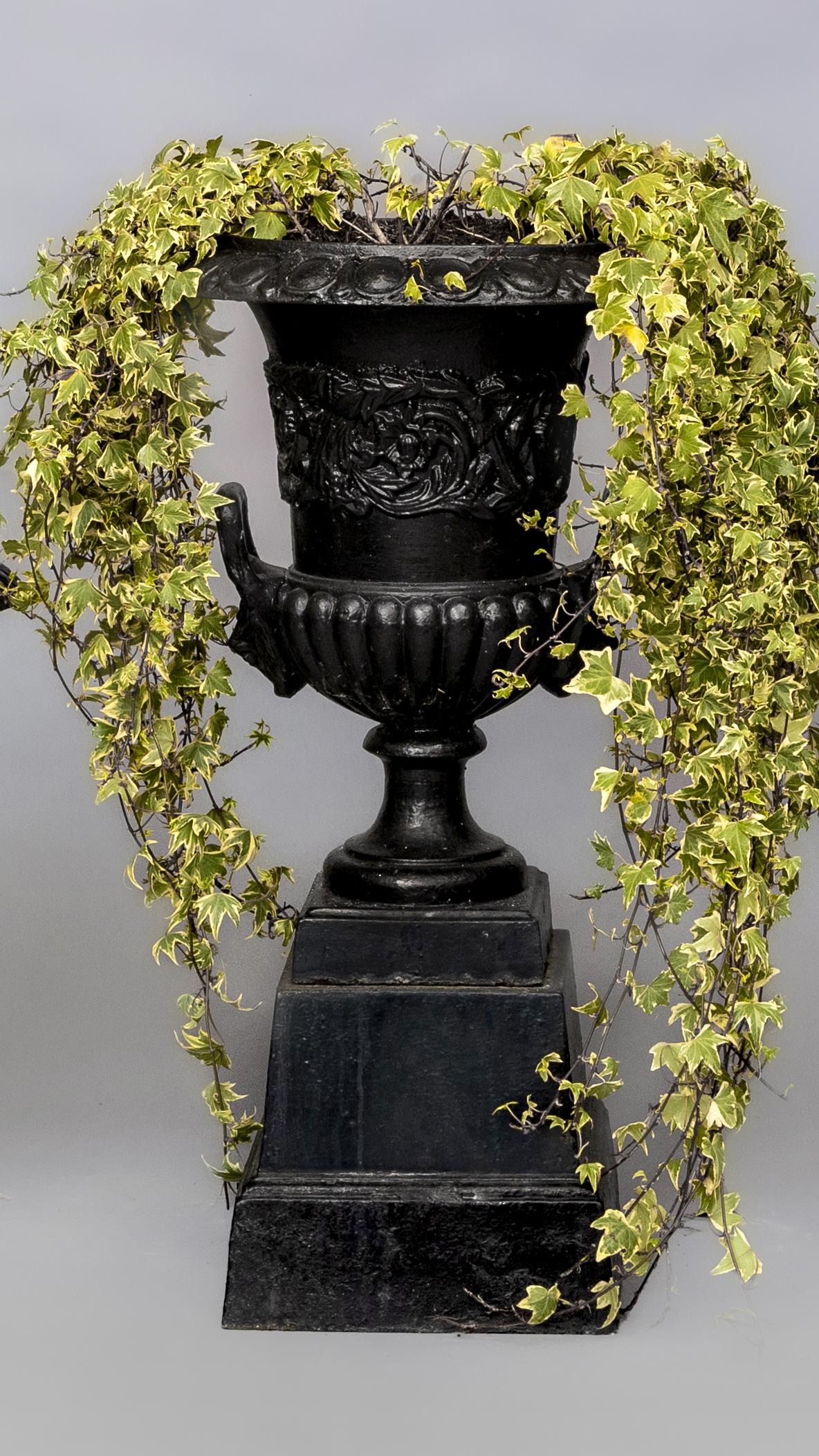 A CAST IRON GARDEN URN of half fluted campana form with lion mask loop handles Image