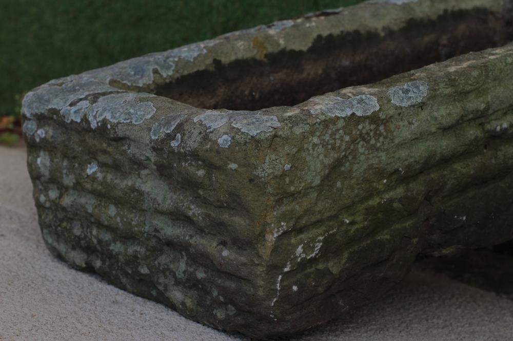 A SANDSTONE TROUGH of rough hewn oblong form, 27 1/2" x 13 1/2" x 72" (Est. plus 24% premium inc. Image
