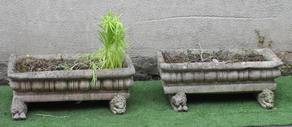 A PAIR OF COMPOSITION STONE JARDINIERES of oblong form with everted rims and cushion moulded sides Image