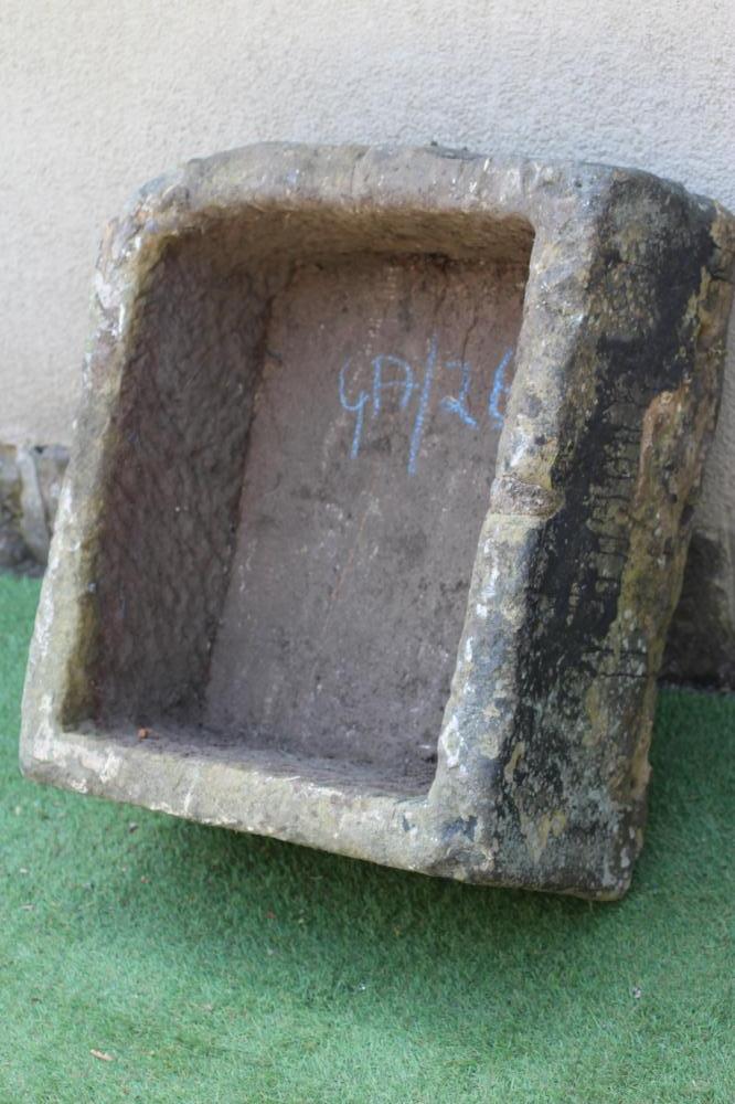 A SANDSTONE TROUGH of rough hewn deep oblong form with one rounded corner, 28 1/4" x 24" x 13" (Est. Image