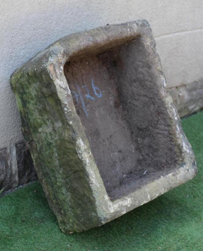A SANDSTONE TROUGH of rough hewn deep oblong form with one rounded corner, 28 1/4" x 24" x 13" (Est. Image