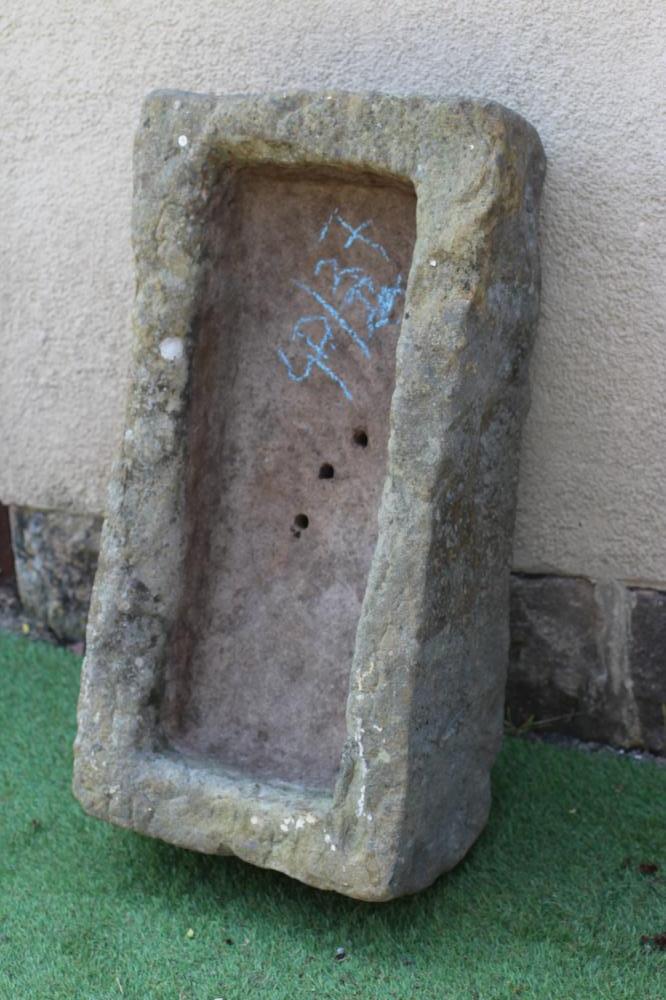 A SANDSTONE TROUGH of rough hewn oblong form, 31 1/2" x 16 1/2" x 9" (Est. plus 24% premium inc. Image