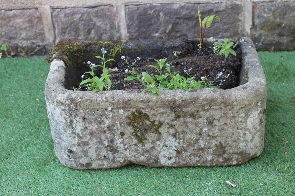 A SANDSTONE TROUGH of rough hewn D form, 25" x 15" x 10 1/2" (Est. plus 24% premium inc. VAT) Image