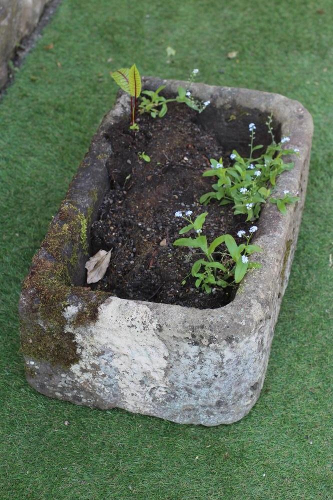 A SANDSTONE TROUGH of rough hewn D form, 25" x 15" x 10 1/2" (Est. plus 24% premium inc. VAT) Image