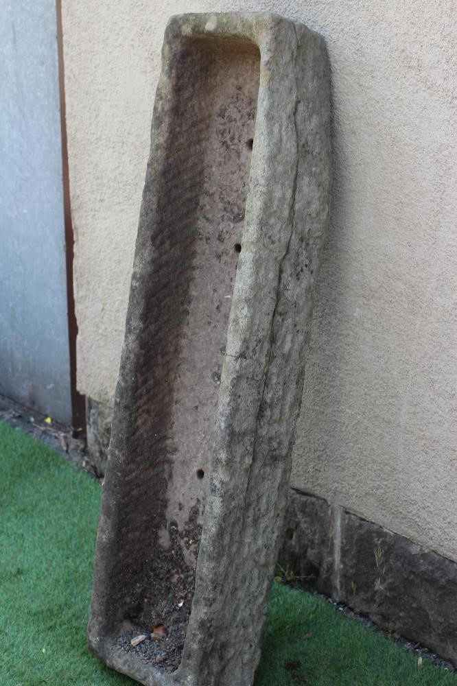 A SANDSTONE TROUGH of rough hewn narrow oblong form, 47 1/2" x 12" x 7 1/2" (Est. plus 24% premium Image