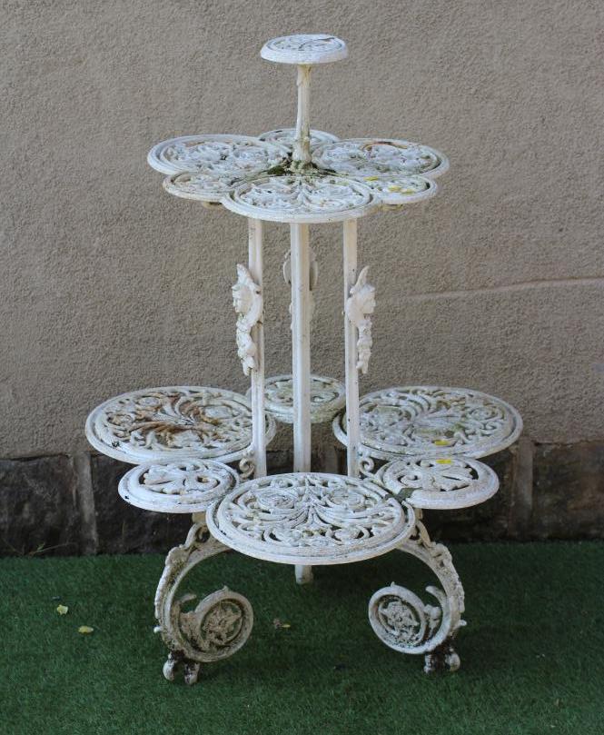 A VICTORIAN CAST IRON CONSERVATORY PLANT STAND of lobed two tier form pierced and moulded with Image