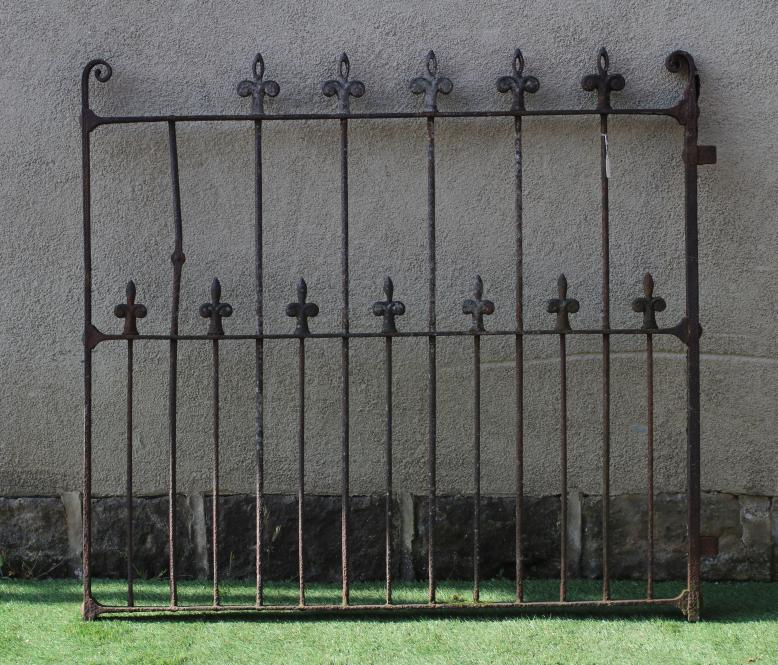 A VICTORIAN CAST IRON GARDEN GATE of two tier barred form with fleur de lys finials and scroll Image