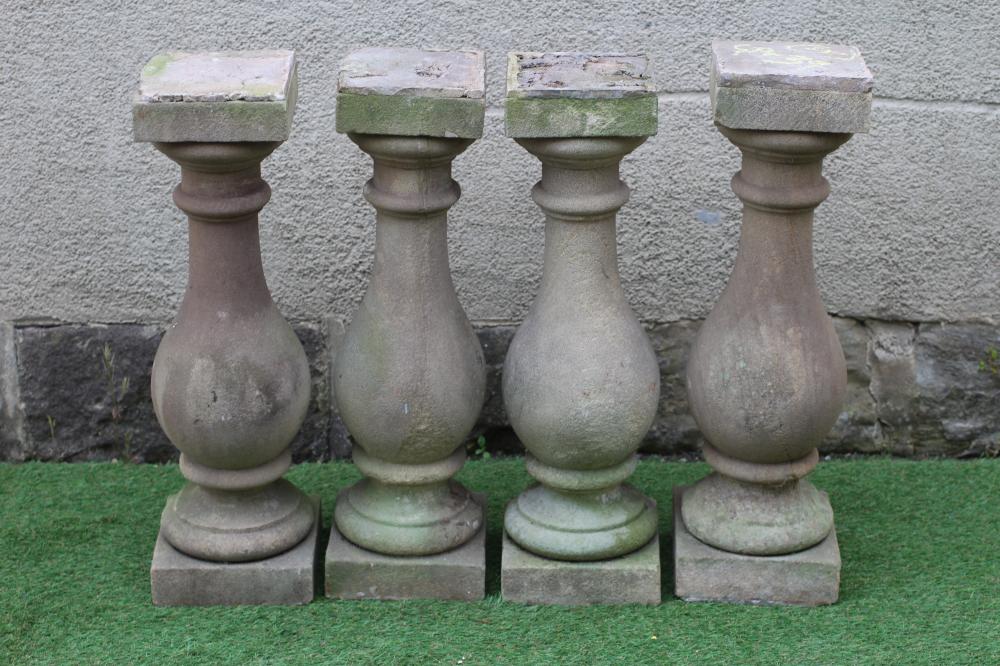 A SET OF FOUR CARVED SANDSTONE BALUSTERS, 19th century, with square capitals and plinths, 8" x 26" Image