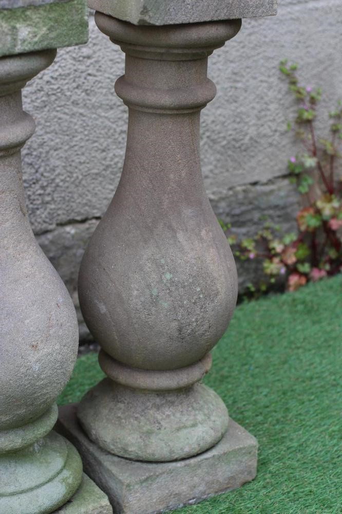 A SET OF FOUR CARVED SANDSTONE BALUSTERS, 19th century, with square capitals and plinths, 8" x 26" Image