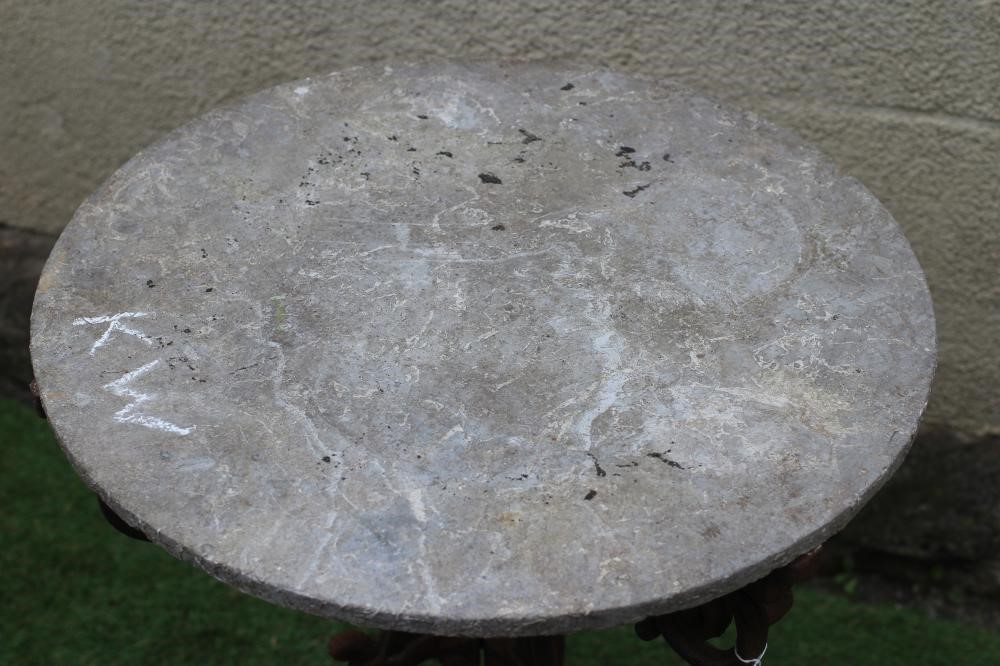 A VICTORIAN CAST IRON TABLE with associated sandstone circular top, the triform scrolling foliate Image