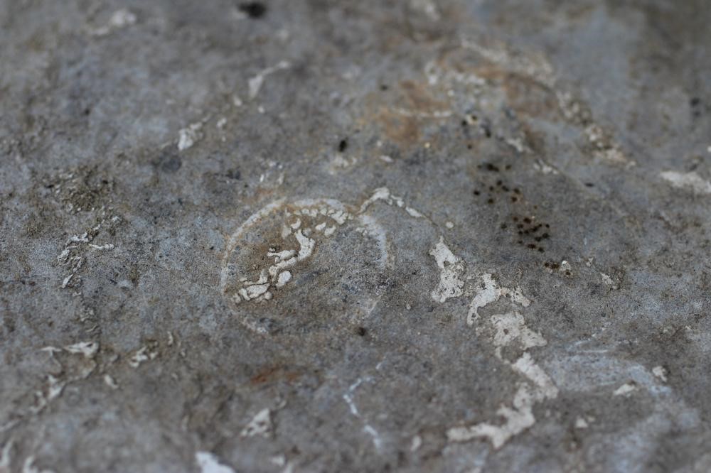 A VICTORIAN CAST IRON TABLE with associated sandstone circular top, the triform scrolling foliate Image