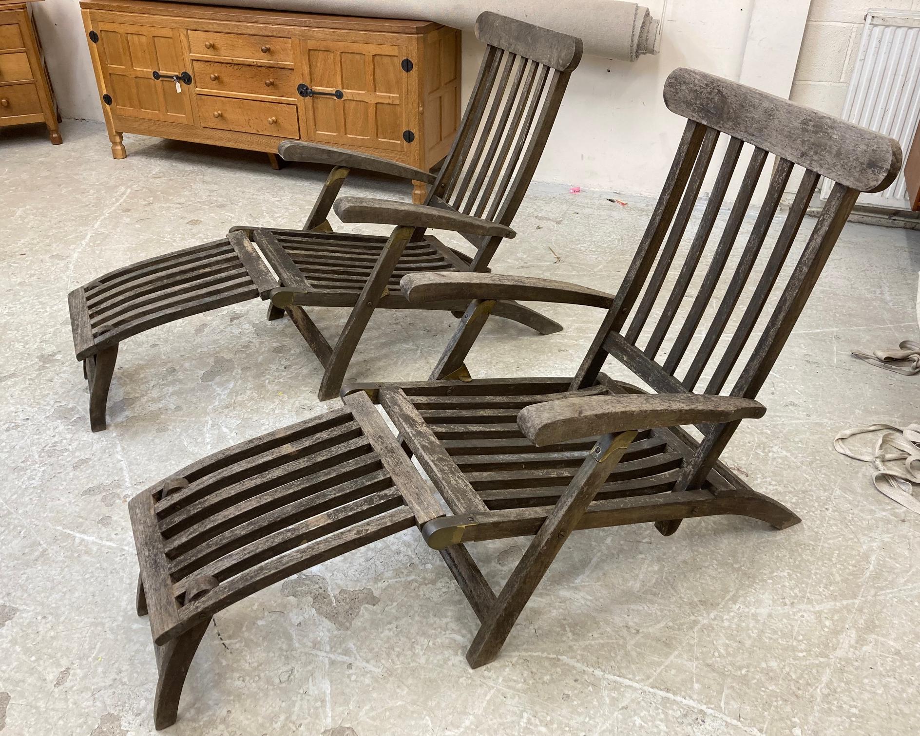 A PAIR OF SLATTED TEAK STEAMER ARMCHAIRS with brass fittings and green weather-proof loose cushions, Image