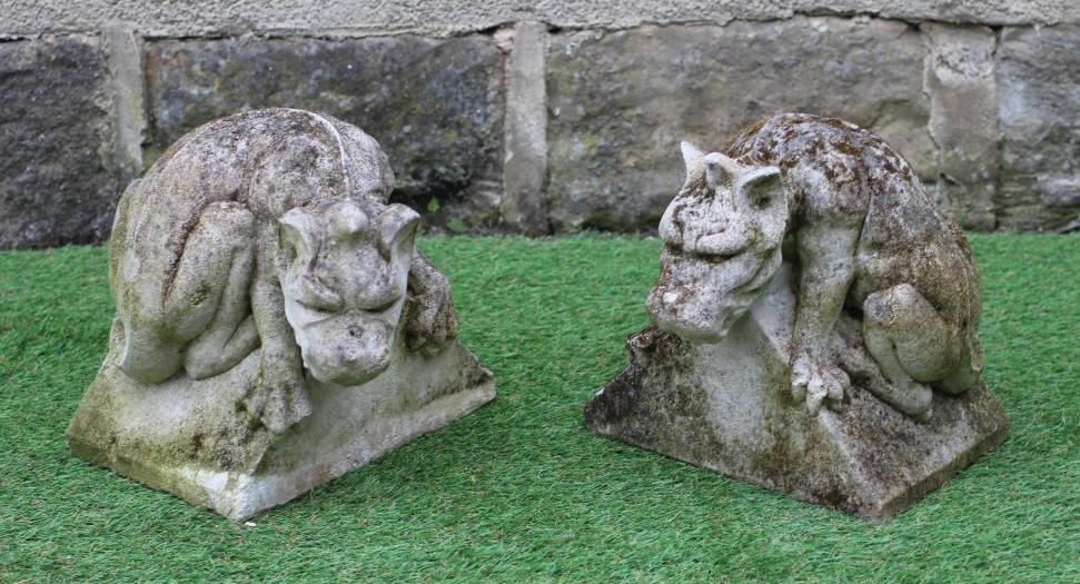 A PAIR OF CAST STONE DRAGON GARGOYLES realistically modelled on a triangular base, 11" x 11" (Est. Image