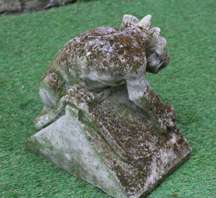 A PAIR OF CAST STONE DRAGON GARGOYLES realistically modelled on a triangular base, 11" x 11" (Est. Image