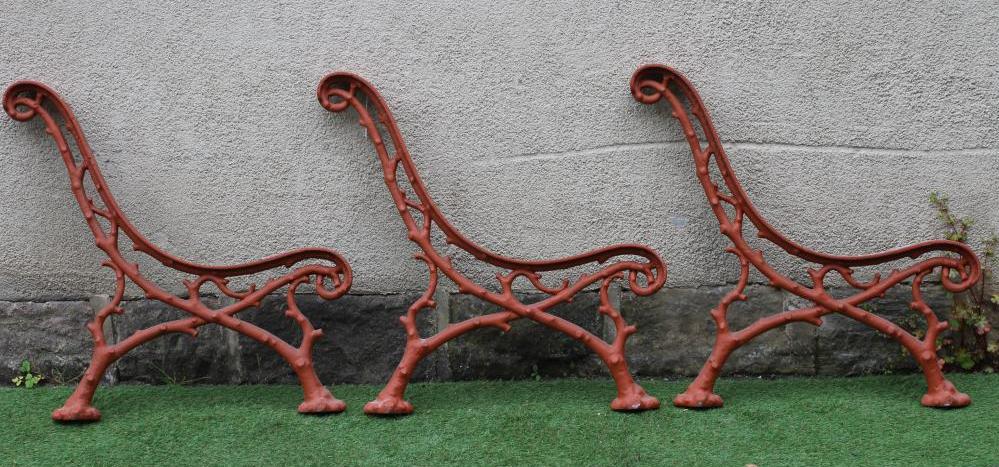 A SET OF THREE VICTORIAN CAST IRON PARK BENCH SUPPORTS in truncated branch pattern, 26 1/2" x 29" Image